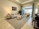Bright living room featuring comfortable seating and access to a relaxing patio at 7709 River Preserve Dr, Bradenton, FL 34212