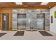 Modern building lobby with two elevators and wood-like wall accents at 101 S Gulfstream Ave # 4F, Sarasota, FL 34236