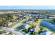 Aerial view of a suburban neighborhood surrounding a body of water at 10817 56Th St E, Parrish, FL 34219