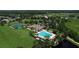 An aerial view of the community pool, clubhouse, and tennis courts surrounded by landscaping at 10817 56Th St E, Parrish, FL 34219