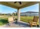 Back porch with an open backyard, rocking chair, and tan bench seating at 10817 56Th St E, Parrish, FL 34219