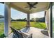 Back porch with an open backyard with a rocking chair and tan bench seating at 10817 56Th St E, Parrish, FL 34219