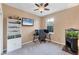 Bedroom setup as an office with gray walls, a ceiling fan, and natural lighting at 10817 56Th St E, Parrish, FL 34219