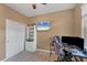 Bedroom setup as an office with gray walls, a ceiling fan, and natural lighting at 10817 56Th St E, Parrish, FL 34219