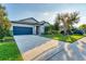 Attractive home with a blue garage door, lush green lawn, and beautiful landscaping at 10817 56Th St E, Parrish, FL 34219