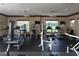 Well-equipped fitness center with treadmills, elliptical machines, weight machines, and ceiling fans at 10817 56Th St E, Parrish, FL 34219