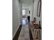 Inviting hallway with dark wood floors and a view into the living area at 10817 56Th St E, Parrish, FL 34219