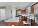 Bright kitchen featuring stainless steel appliances, wooden cabinetry, and a white quartz countertop island at 10817 56Th St E, Parrish, FL 34219