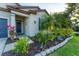 Lush front yard featuring colorful plants, mulch beds, and decorative stone edging at 10817 56Th St E, Parrish, FL 34219