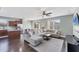 Living room featuring a sectional sofa, ceiling fan, and connectivity to the eat-in kitchen at 10817 56Th St E, Parrish, FL 34219