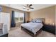 Cozy main bedroom with a ceiling fan, window and neutral decor at 10817 56Th St E, Parrish, FL 34219