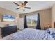 Relaxing main bedroom features a ceiling fan, backyard view, and neutral decor at 10817 56Th St E, Parrish, FL 34219