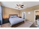 Comfortable main bedroom with a ceiling fan, natural light, and a walk-in closet at 10817 56Th St E, Parrish, FL 34219