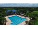 Beautiful swimming pool with many lounge chairs and views of the lake and natural scenery at 10817 56Th St E, Parrish, FL 34219