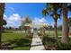 Scenic walkway leading to the community's tennis court, beautifully landscaped for an inviting atmosphere at 10817 56Th St E, Parrish, FL 34219