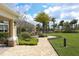 Well-manicured grounds showcase a brick walkway leading to clubhouse with covered patio at 10817 56Th St E, Parrish, FL 34219