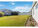 Backyard view with grassy lawn and white fence at 10931 Blue Magnolia Ln, Parrish, FL 34219