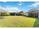 Large backyard with grassy lawn and mature trees at 10931 Blue Magnolia Ln, Parrish, FL 34219