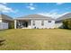 Home's exterior and backyard with grassy lawn at 10931 Blue Magnolia Ln, Parrish, FL 34219