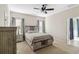 Spacious bedroom with carpeted floor, ceiling fan, and ample natural light at 10931 Blue Magnolia Ln, Parrish, FL 34219