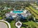 Aerial view showing community pool and clubhouse at 10931 Blue Magnolia Ln, Parrish, FL 34219