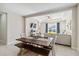 Open concept dining room with farmhouse table and view to the living room at 10931 Blue Magnolia Ln, Parrish, FL 34219