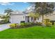 Beautiful one-story home with a landscaped lawn and attached garage at 10931 Blue Magnolia Ln, Parrish, FL 34219