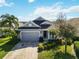 Single-story home with gray siding and two-car garage at 10931 Blue Magnolia Ln, Parrish, FL 34219