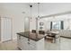 Spacious kitchen island with granite countertops and white cabinets at 10931 Blue Magnolia Ln, Parrish, FL 34219