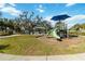 Community playground with playset, shade structures, and benches at 10931 Blue Magnolia Ln, Parrish, FL 34219