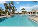 Large community pool with plenty of lounge chairs at 10931 Blue Magnolia Ln, Parrish, FL 34219