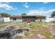 Backyard with a screened-in porch and a red barbecue grill on a sunny day at 1119 76Th Nw St, Bradenton, FL 34209