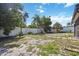 Large backyard with a white privacy fence and mature trees at 1119 76Th Nw St, Bradenton, FL 34209