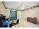 Bedroom features tiled floors, ceiling fan, a wall of closets, and a small desk at 1119 76Th Nw St, Bradenton, FL 34209