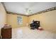 Bedroom with a ceiling fan, tile floor, a window, and simple furnishings at 1119 76Th Nw St, Bradenton, FL 34209