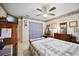 Cozy bedroom featuring patterned wallpaper, ceiling fan, and a large window with natural light at 1119 76Th Nw St, Bradenton, FL 34209