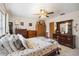 Bedroom with natural light, ceiling fan, decorative furniture, and floral-patterned comforter at 1119 76Th Nw St, Bradenton, FL 34209