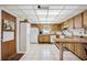 Functional kitchen with wood cabinets and a breakfast bar at 1119 76Th Nw St, Bradenton, FL 34209