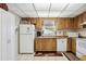 Cozy kitchen with wood cabinets and white appliances at 1119 76Th Nw St, Bradenton, FL 34209