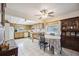 Eat-in kitchen featuring tile floors, wooden cabinets, and bright natural light at 1119 76Th Nw St, Bradenton, FL 34209