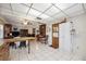 Open kitchen with white tile floors, wood cabinets, and an eat-in peninsula looks into the living area at 1119 76Th Nw St, Bradenton, FL 34209