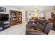 Bright living room with two brown leather recliners and built-in shelving at 1119 76Th Nw St, Bradenton, FL 34209