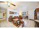 Comfortable living room features tile flooring, a ceiling fan, and classic wooden furniture at 1119 76Th Nw St, Bradenton, FL 34209