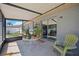 Relaxing screened patio features a table with lush plants and a view of the backyard at 1119 76Th Nw St, Bradenton, FL 34209