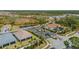 Aerial view of a luxury community with houses, landscaping, and a lake at 116 Daylily Blvd, Nokomis, FL 34275