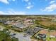 Aerial view of upscale homes, lush landscape, and a tranquil lake at 116 Daylily Blvd, Nokomis, FL 34275