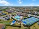 Aerial view of community with pool, pickleball courts, bocce, and houses at 116 Daylily Blvd, Nokomis, FL 34275