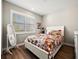 Bright bedroom with a floral comforter and a large window with shutters at 116 Daylily Blvd, Nokomis, FL 34275