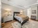 Elegant bedroom with king-size bed and en suite bathroom access at 116 Daylily Blvd, Nokomis, FL 34275