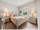 Light-filled bedroom with a queen-size bed and ensuite bath at 116 Daylily Blvd, Nokomis, FL 34275